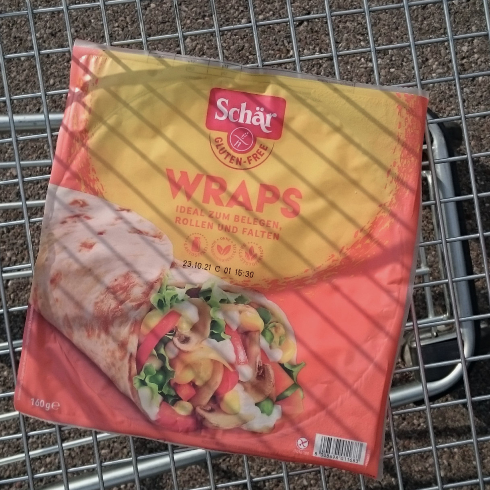A pack of glutenfree wraps in a shopping cart.