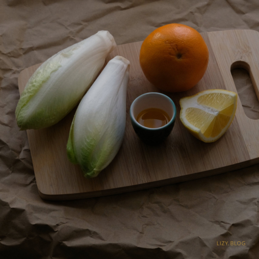 Ingredients for a salad with chicory and orange.
