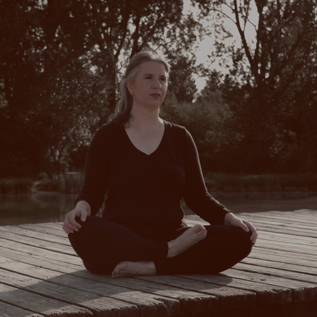 Lizy is meditating at the lake.