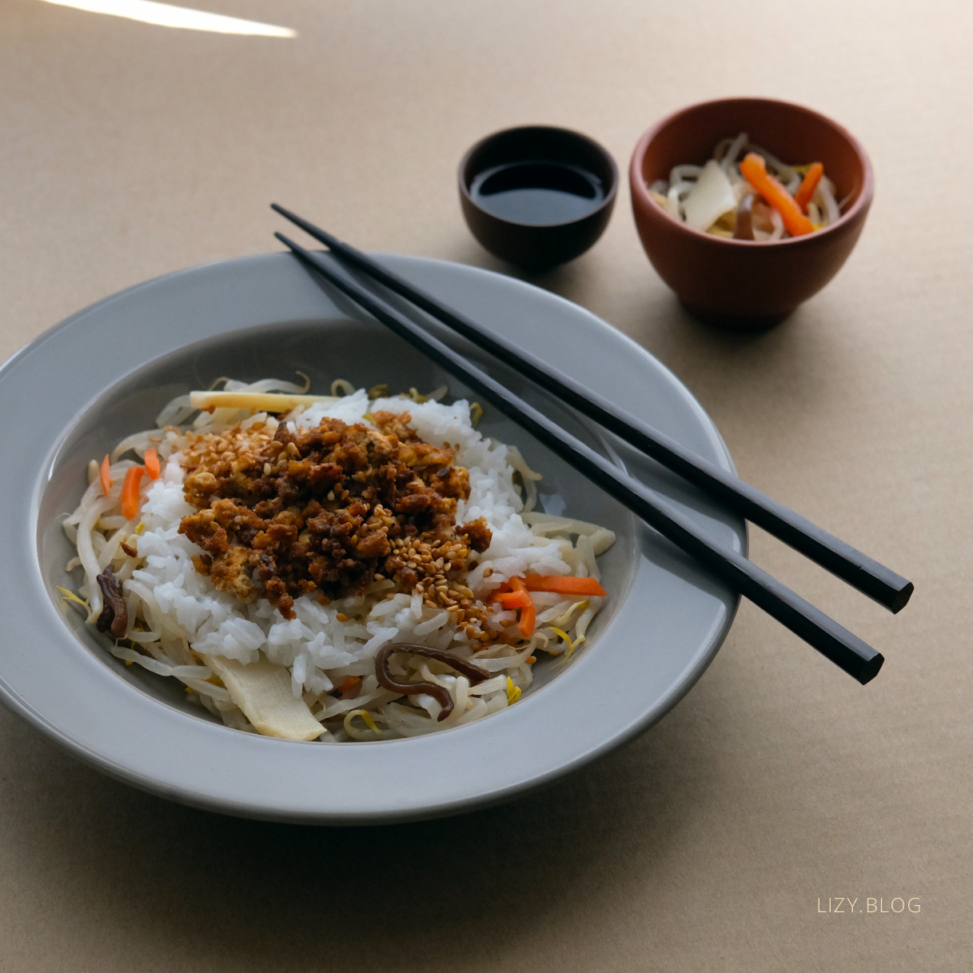 Tofu, rice and veggies arranged on a plate.