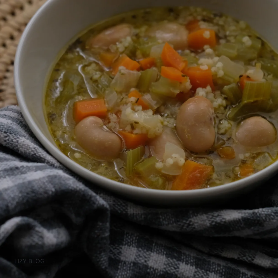 A bowl of soup with millets and butter beans.